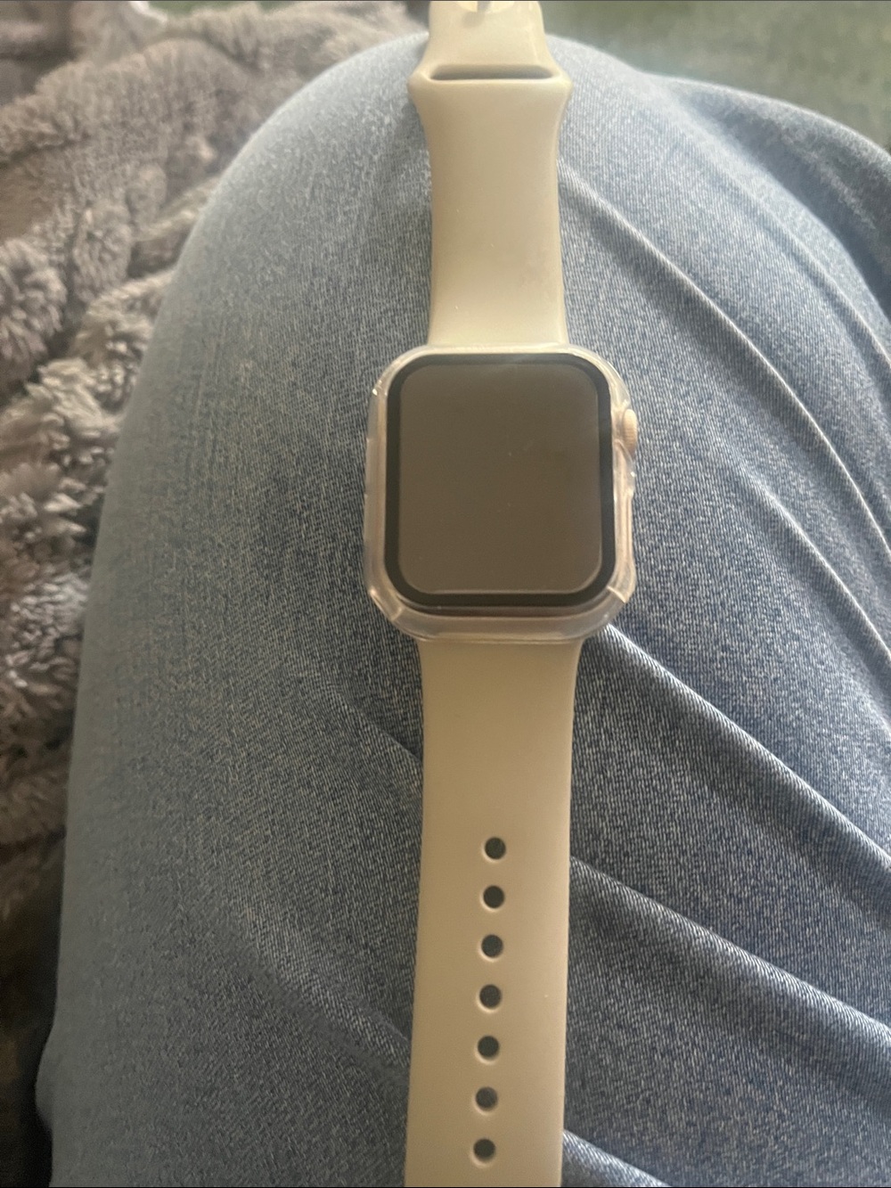 Women’s Apple Smartwatch series 7 with gray band.
